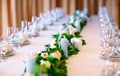 Wedding table settings. Empty plates and glasses on a white tablecloth. Royalty Free Stock Photo