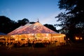 Wedding tent at night - Special event tent lit up from the inside with dusk sky and trees Royalty Free Stock Photo