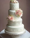 Wedding Theme, Modern style high detailed multi-tiered wedding cake intricate motif with white and soft peach color rose Royalty Free Stock Photo