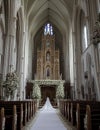 Wedding Theme, Wide angle picture of large empty royal cathedral style church, prepared for wedding with flowers and runner