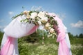 Wedding traditional arch with flower decor on blue sky background