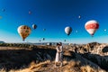 Wedding travel. Honeymoon trip. Couple in love among balloons. A guy proposes to a girl. Couple in love in Cappadocia. Couple in