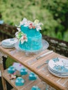 Wedding turquoise cake with flowers and gifts.