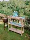 Wedding turquoise cake with sugar flowers and drinks with gifts. Wedding banquet