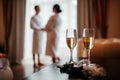 wedding, two glasses of champagne, and on the background of the bride and groom Royalty Free Stock Photo