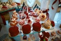 Wedding variety dessert cakes with tasty buffet color decorated with whipped cream, candy bar, buffet, red valentine`s heart