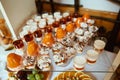 Wedding variety dessert cakes with tasty buffet color decorated with whipped orange cream, candy bar, sweet buffet