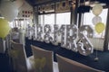 A wedding venue with chairs laid out with an illuminated sign that reads Mr and Mrs