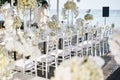 The wedding venue for reception dinner table decorated with white orchids, white roses, flowers, floral, white chiavari chairs Royalty Free Stock Photo