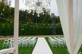 Wedding venue. White chairs on green grass with night lights. Wedding Set Up. Wedding setting. Royalty Free Stock Photo