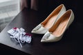 Wedding white bride shoes with silver earrings Royalty Free Stock Photo