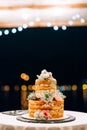 Wedding white bunk cake on a table at night Royalty Free Stock Photo