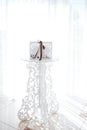 Wedding white openwork wooden box on a white tracery stand. concept of wedding decor