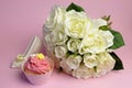 Wedding white roses bouquet with pink cupcake Royalty Free Stock Photo