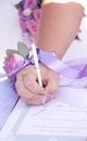 The wedding, the witness puts his signature on the document Royalty Free Stock Photo