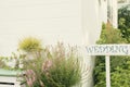 Wedding Wood Sign against the green blur background. Wooden signboard with the inscription in white paint wedding. Royalty Free Stock Photo