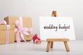 Wedding word on easel, present boxes on a table