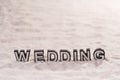 Wedding word on white sand