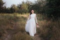 Wedding. Young beautiful bride with hairstyle and makeup posing in white dress. Royalty Free Stock Photo