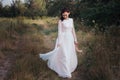 Wedding. Young beautiful bride with hairstyle and makeup posing in white dress. Royalty Free Stock Photo