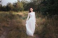 Wedding. Young beautiful bride with hairstyle and makeup posing in white dress.