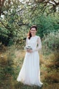 Wedding. Young beautiful bride with hairstyle and makeup posing in white dress. Royalty Free Stock Photo