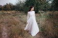 Wedding. Young beautiful bride with hairstyle and makeup posing in white dress. Royalty Free Stock Photo