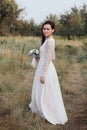 Wedding. Young beautiful bride with hairstyle and makeup posing in white dress. Royalty Free Stock Photo