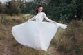 Wedding. Young beautiful bride with hairstyle and makeup posing in white dress.