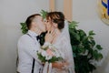 Wedding: young couple in love bride and groom hugging each other holding a bouquet of flowers. Two lovers hearts on the Royalty Free Stock Photo