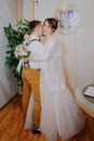 Wedding: young couple in love bride and groom hugging each other holding a bouquet of flowers. Two lovers hearts on the Royalty Free Stock Photo