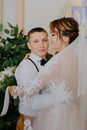 Wedding: young couple in love bride and groom hugging each other holding a bouquet of flowers. Two lovers hearts on the Royalty Free Stock Photo