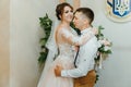 Wedding: young couple in love bride and groom hugging each other holding a bouquet of flowers. Two lovers hearts on the Royalty Free Stock Photo