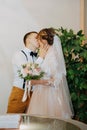 Wedding: young couple in love bride and groom hugging each other holding a bouquet of flowers. Two lovers hearts on the Royalty Free Stock Photo