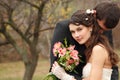 Wedding, young groom kiss bride in love over autumn nature backg