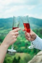 Glasses with red champagne drink in bride and groom hands. Happy newlyweds drinking. Loving couple created new family. Royalty Free Stock Photo