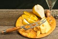Wedge of cheese, cheese knife, and pear as pairings for a french wine tasting event Royalty Free Stock Photo