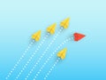 Wedge of paper planes flying in one direction, one red plane flying in the other direction Royalty Free Stock Photo