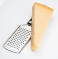 Wedge of Parmesan cheese or grana with grater.