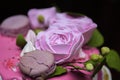 Weding cake with roses and cookies with water droplets on the petals