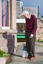 Weed killer spray using pump action bottle in garden Royalty Free Stock Photo