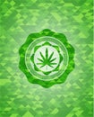 Weed leaf icon inside green emblem. Mosaic background
