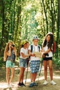 Weekend activies. Kids strolling in the forest with travel equipment Royalty Free Stock Photo
