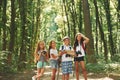 Weekend activies. Kids strolling in the forest with travel equipment Royalty Free Stock Photo