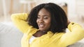 Black woman having rest at home on the sofa Royalty Free Stock Photo