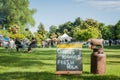 Weekend Farmers Market sign with groups of people sitting around