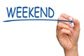 Weekend - female hand writing blue text Royalty Free Stock Photo