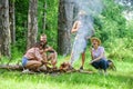 Weekend in forest benefits. Roasting marshmallows popular group activity around bonfire. Company friends prepare roasted Royalty Free Stock Photo