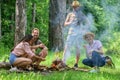 Weekend in forest benefits. Roasting marshmallows popular group activity around bonfire. Youth at picnic roasting Royalty Free Stock Photo