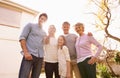 Weekend with grandma and grandpa. A portrait of a happy multi-generation family standing outdoors. Royalty Free Stock Photo